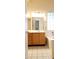 Bright bathroom features a bathtub, light tile floor, and wooden vanity with drawers at 7825 W Crocus Dr, Peoria, AZ 85381