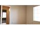 Neutral bedroom featuring natural light with view into hallway with tile floor and lighting fixture at 7825 W Crocus Dr, Peoria, AZ 85381