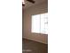 Bedroom view showing window with blind and patterned carpet at 7825 W Crocus Dr, Peoria, AZ 85381