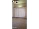 Bedroom with carpet, white sliding door closet, and vaulted ceilings at 7825 W Crocus Dr, Peoria, AZ 85381