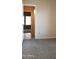 Bedroom view highlighting the patterned carpet and tile hallway with lighting fixture at 7825 W Crocus Dr, Peoria, AZ 85381
