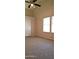 Bedroom with a vaulted ceiling, a carpeted floor and a window with blinds at 7825 W Crocus Dr, Peoria, AZ 85381