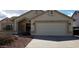 Charming single-story house with a well-maintained front yard and a two-car garage at 7825 W Crocus Dr, Peoria, AZ 85381