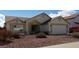 Inviting home exterior with lovely landscaping and a two-car garage at 7825 W Crocus Dr, Peoria, AZ 85381