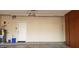Functional garage area with water heater, storage and an entrance door at 7825 W Crocus Dr, Peoria, AZ 85381