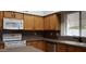 Well-equipped kitchen featuring wooden cabinets, a white microwave, and a white oven at 7825 W Crocus Dr, Peoria, AZ 85381