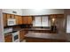 Spacious kitchen with wooden cabinets, stainless steel appliances, and a breakfast bar at 7825 W Crocus Dr, Peoria, AZ 85381