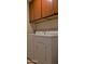 A laundry room with a washer and dryer underneath wooden cabinets at 7825 W Crocus Dr, Peoria, AZ 85381