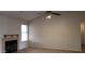 Cozy living room with vaulted ceiling, ceiling fan, and a fireplace for added comfort at 7825 W Crocus Dr, Peoria, AZ 85381