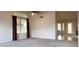 Bright living room featuring neutral carpet, ceiling fan and natural light from large windows at 7825 W Crocus Dr, Peoria, AZ 85381