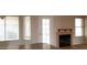 Bright living room with large windows, fireplace, and convenient access to the outside at 7825 W Crocus Dr, Peoria, AZ 85381