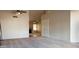 Spacious living room with neutral carpet, ceiling fan, and fireplace in the adjoining room at 7825 W Crocus Dr, Peoria, AZ 85381