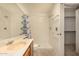 Tiled bathroom featuring a walk-in shower and a large mirror at 8140 N 107Th Ave # 287, Peoria, AZ 85345