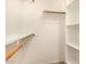 Bright walk-in closet with wooden rods and shelving at 8140 N 107Th Ave # 287, Peoria, AZ 85345