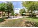 Exterior shot of a common area featuring picnic tables and mature trees at 8140 N 107Th Ave # 287, Peoria, AZ 85345