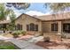 Charming single-story home featuring a landscaped front yard with desert landscaping, textured stucco, and a covered entryway at 8140 N 107Th Ave # 287, Peoria, AZ 85345