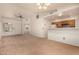 Bright, open-concept living room features neutral carpet, vaulted ceilings, fan, and a view into the kitchen at 8140 N 107Th Ave # 287, Peoria, AZ 85345
