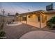 Landscaped backyard with gravel, concrete patio, outdoor lighting, and a modern fire pit at 8408 E Rancho Vista Dr, Scottsdale, AZ 85251