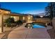 Backyard oasis with pool, rock features, mature landscaping, and covered patio at 8408 E Rancho Vista Dr, Scottsdale, AZ 85251
