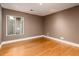 An empty bedroom with a window, neutral walls, hardwood flooring, and recessed lighting at 8408 E Rancho Vista Dr, Scottsdale, AZ 85251