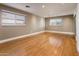 A bright, empty bedroom showcasing hardwood floors and natural light from two windows at 8408 E Rancho Vista Dr, Scottsdale, AZ 85251