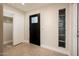 Inviting foyer featuring neutral tile flooring, a modern front door, and abundant natural light at 8408 E Rancho Vista Dr, Scottsdale, AZ 85251