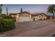 A home featuring a paver driveway, desert landscaping, and a well-maintained front exterior at 8408 E Rancho Vista Dr, Scottsdale, AZ 85251