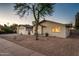 A charming single-story home featuring desert landscaping and an inviting facade with a decorative tree at 8408 E Rancho Vista Dr, Scottsdale, AZ 85251