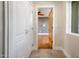 Hallway features tile floor, closet, and views of a bedroom with wood-look flooring and ceiling fan at 8408 E Rancho Vista Dr, Scottsdale, AZ 85251