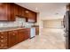 Gourmet kitchen features stainless steel appliances, custom cabinets, granite countertops, and mosaic tile backsplash at 8408 E Rancho Vista Dr, Scottsdale, AZ 85251