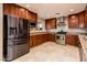 Gourmet kitchen features stainless steel appliances, custom cabinets, granite countertops, and mosaic tile backsplash at 8408 E Rancho Vista Dr, Scottsdale, AZ 85251