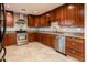 Updated kitchen features custom wood cabinets, stainless steel appliances, granite countertops, and mosaic tile backsplash at 8408 E Rancho Vista Dr, Scottsdale, AZ 85251