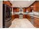 Well-appointed kitchen with dark wood cabinets, stainless steel appliances, and tiled backsplash at 8408 E Rancho Vista Dr, Scottsdale, AZ 85251
