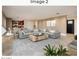 A spacious living room with a large gray sectional, a wooden coffee table, and an area rug at 8408 E Rancho Vista Dr, Scottsdale, AZ 85251