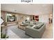 Spacious living area featuring a large sectional, modern decor, and seamless flow to the kitchen and dining area at 8408 E Rancho Vista Dr, Scottsdale, AZ 85251