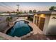 Backyard pool features rock accents, overhead shade, and lush greenery, creating an inviting retreat at 8408 E Rancho Vista Dr, Scottsdale, AZ 85251