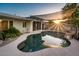 Backyard pool with rock features and overhead shade sail creates an inviting outdoor oasis at 8408 E Rancho Vista Dr, Scottsdale, AZ 85251