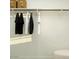 Neat closet with hanging clothes and open shelf storage with baskets at 9550 W Catalina Dr, Phoenix, AZ 85037