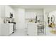 Bright, modern kitchen with white cabinets, stainless steel appliances, and an island with bar seating at 9550 W Catalina Dr, Phoenix, AZ 85037