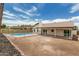 Backyard featuring pool, grass, a covered patio, a block wall and a wrought iron fence at 11021 N 55Th Dr, Glendale, AZ 85304