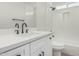 Modern bathroom features white cabinets, a quartz countertop, and a tiled shower-tub combo at 11021 N 55Th Dr, Glendale, AZ 85304