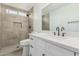 Modern bathroom features stone-look tile shower, white cabinets, a quartz countertop, and black hardware at 11021 N 55Th Dr, Glendale, AZ 85304