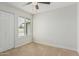 Bright bedroom featuring carpet, neutral paint, and large window at 11021 N 55Th Dr, Glendale, AZ 85304