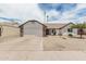 Charming single-story home with a two car garage and low maintenance desert landscaping in front at 11021 N 55Th Dr, Glendale, AZ 85304