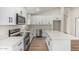 Modern kitchen with white cabinets, stainless steel appliances, and an island countertop at 11021 N 55Th Dr, Glendale, AZ 85304