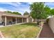 Well-maintained backyard with green grass, covered patio, seating area, and barbecue grill at 1114 N Leland Ct, Gilbert, AZ 85233