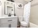Stylishly renovated bathroom features a black faucet, modern lighting, and a shower with a polka dot curtain at 1114 N Leland Ct, Gilbert, AZ 85233