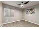 Bright bedroom featuring carpet floors, a window, and a ceiling fan at 1114 N Leland Ct, Gilbert, AZ 85233