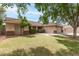 Charming single-story home featuring a well-manicured lawn, desert landscaping, and a two-car garage at 1114 N Leland Ct, Gilbert, AZ 85233