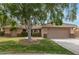Charming single-story home featuring a well-manicured lawn, desert landscaping, and a two-car garage at 1114 N Leland Ct, Gilbert, AZ 85233